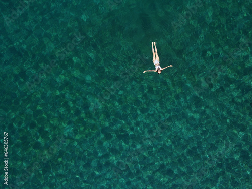 Wall Mural Above view of woman swimming at sea