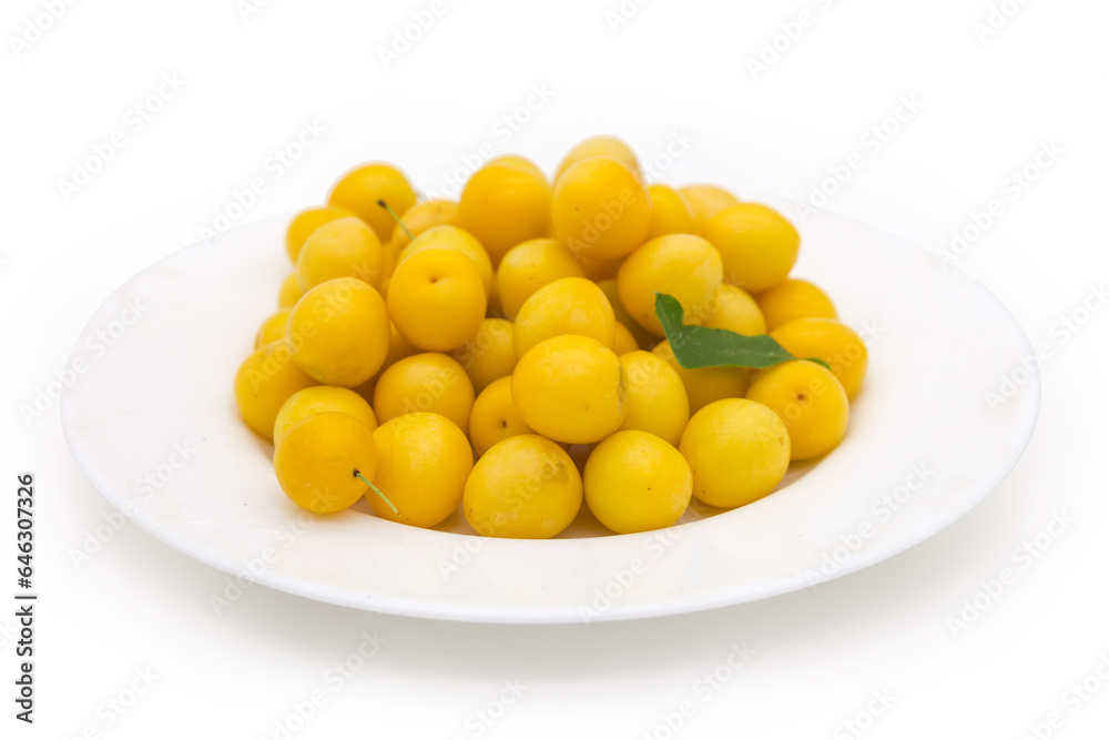 Yellow cherry plums on dish, side view in selective focus Yellow cherry plums on dish, side view in selective focus
