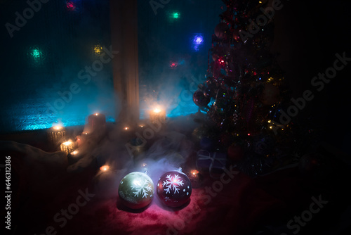 Festive background. Christmas decorations. Santa Claus (or Snowman) standing on snow with beautiful decorated background with holiday elements. Selective focus. Empty space for your text