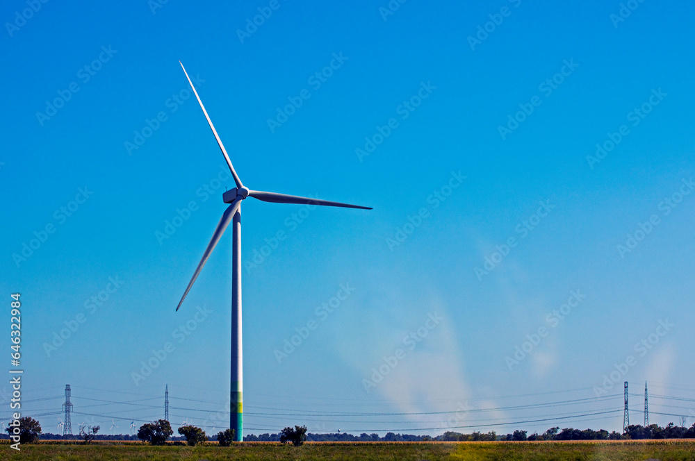windmill against the blue sky. Ecological energy. World energy crisis