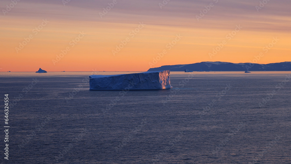 Iceberg seen from cruise ship vacation near Greenland coast in Arctic circle near Ilulissat Disko Bay.