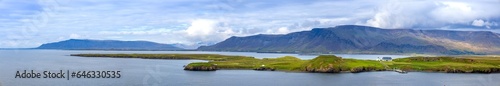 Panoramic view of typical scenic landscape in Iceland with pastures near fjords and glaciers.