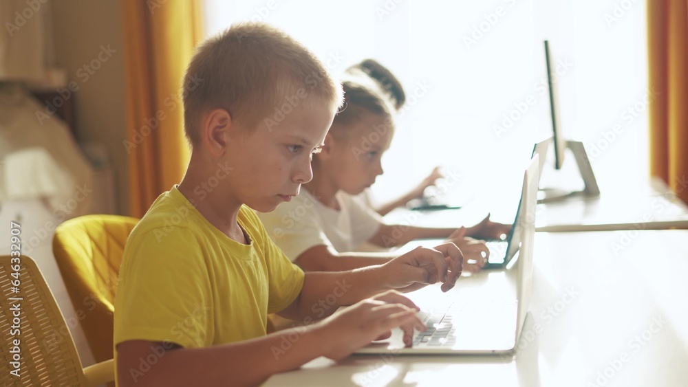 lifestyle children learn from home through computers. business concept of modern training and development. a group of little kids perform tasks in a laptop at home schooling. educating from home lifestyle children learn from home through computers. business concept of modern training and development. a group of little kids perform tasks in a laptop at home schooling. educating from home