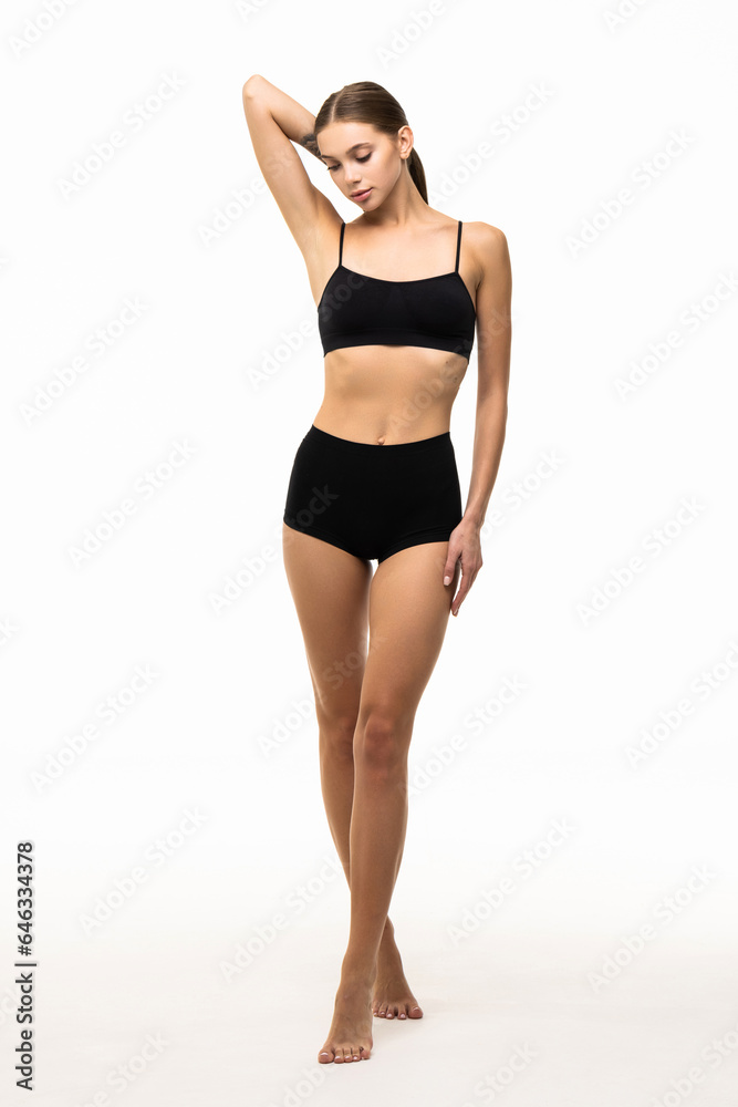 Sexy young woman in black panties checking cellulite on her legs hip. Sexy young woman in black panties checking cellulite on her legs hip.