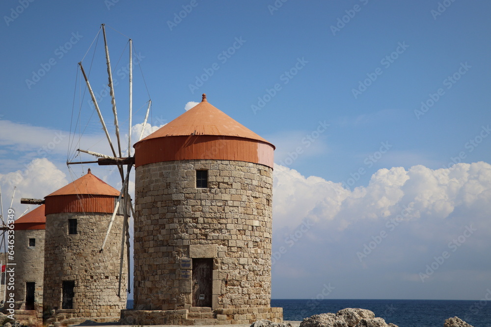 Windmills at the seafront in the city of Rhodes in Rhodes island in Greece Windmills at the seafront in the city of Rhodes in Rhodes island in Greece