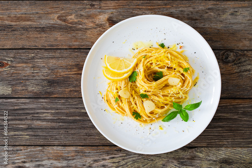 Linguine al limone - pasta with lemon and parmesan on wooden background
 photo