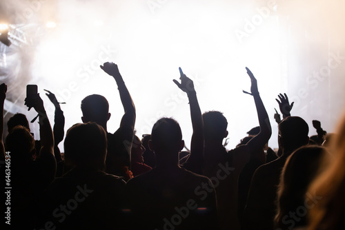 Abstract photo of crowd at concert and blurred stage lights.