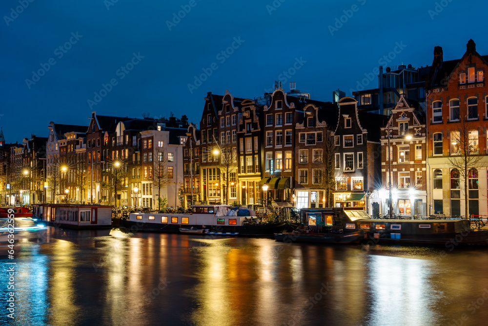 Illuminated Canals and Riverside Delights: Exploring Amsterdam After Dark. Captivating Cityscape of Amsterdam at Night: A Delightful Blend of Tradition and Modernity
