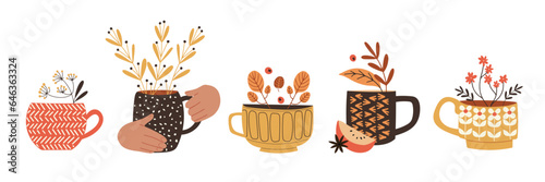 Cute set with cups and mugs, decorated with seasonal plants and branches. Herbal tea or mulled wine. Isolated vector illustration in flat design