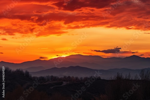 landscape of orange sky with mountains and clouds