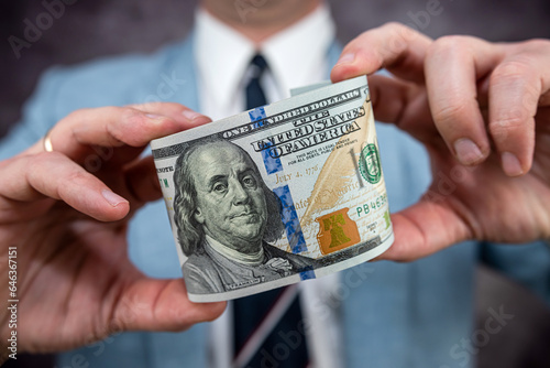 closeup businessman in suit holding one hundred 100 dollar bill