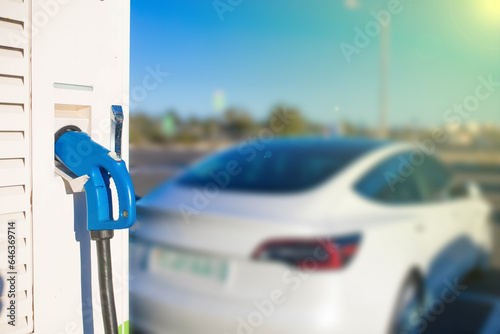 charging an electric car during the day photo