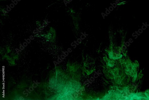 Green colorful dye on black background,Art abstract smoke texture,Colored liquid dye,Splash paint,Abstract color,Abstract Textures
