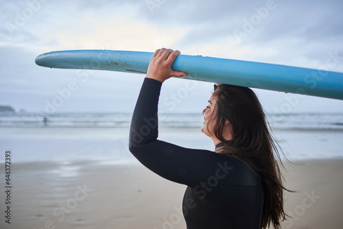 Photography Cute body positive woman carrying surfboard on head and enjoying of the summer