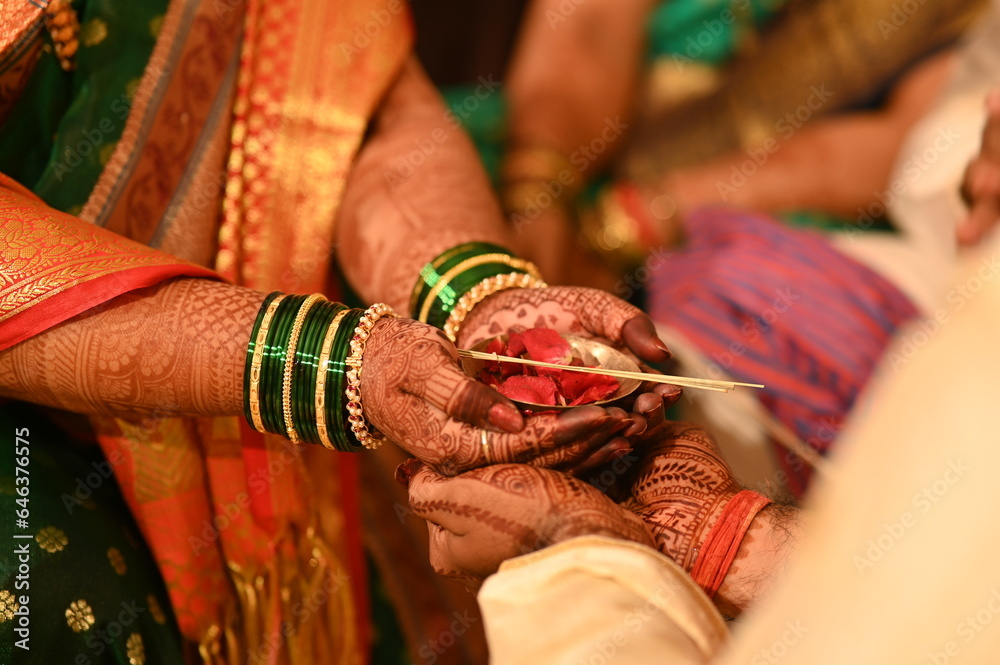 Small Bow with rose petals in hands of bride. Bride and groom holding hands. Kanyadaan Wedding Ceremony. Marathi Wedding Rituals and Ceremony. Maharashtra culture. Indian Bride and Groom. Indian Marri
