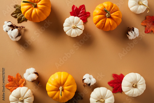 Flat lay composition with pumpkins  maple leaves  cotton on brown background. Happy Thanksgiving  Harvest concept.