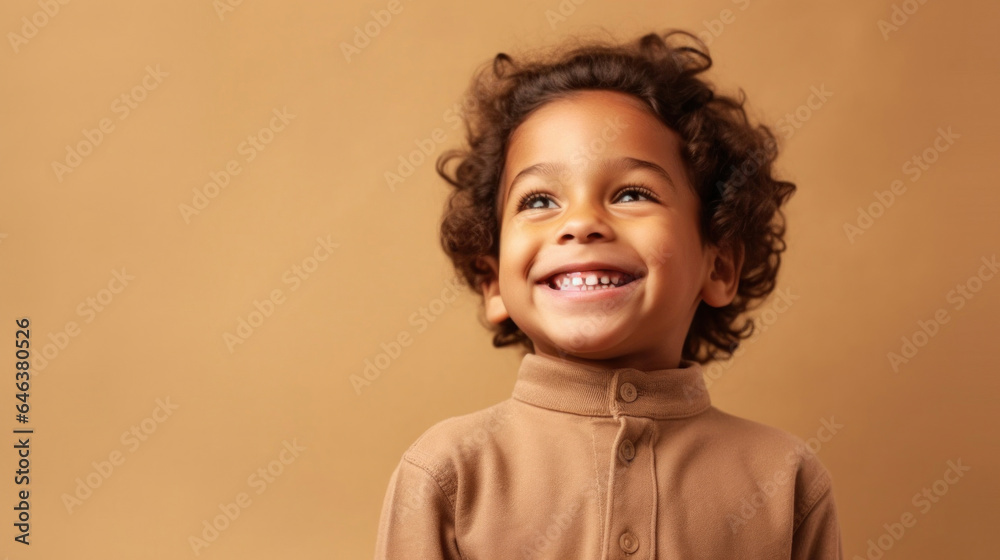 A young child in muted clothes beams while standing against a studio beige backdrop. Generative AI A young child in muted clothes beams while standing against a studio beige backdrop. Generative AI