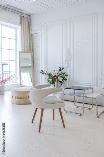 interior of a bright living room in a luxurious baroque style with white walls decorated with antique stucco © 4595886