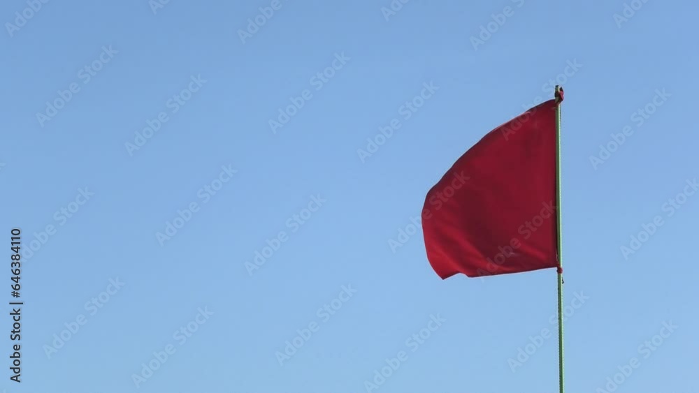 Red flag fluttering in the wind