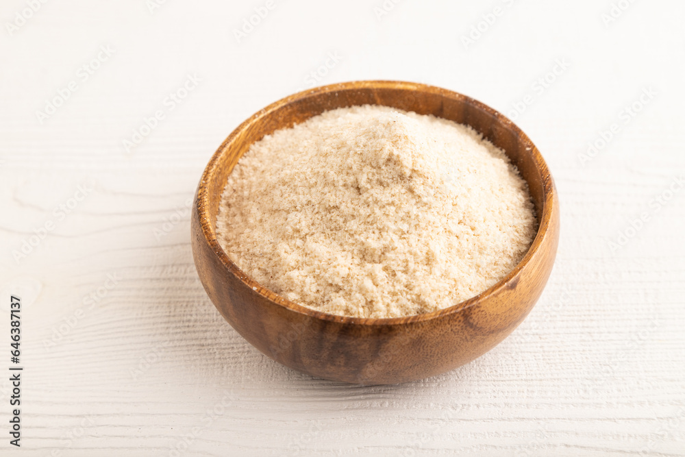 Powdered milk and buckwheat baby food mix, on white wooden, side view Powdered milk and buckwheat baby food mix, on white wooden, side view