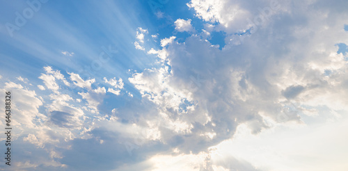 Blue sky with clouds and sunshine reflection. Sunny bright cloudy skyline  blue daylight. Peaceful beautiful sunlight  sun rays beams. Tranquil Earth World environment day panoramic concept background