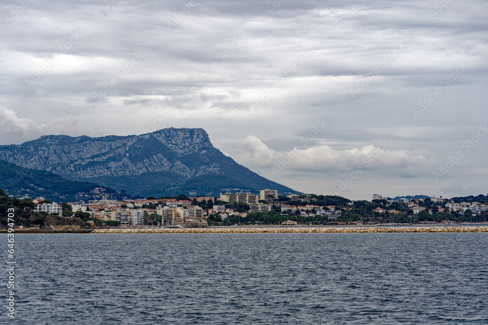 Bay of Mediterranean Sea with skyline of French City of Toulon on a cloudy late spring day. Photo taken June 9th, 2023, Toulon, France.
