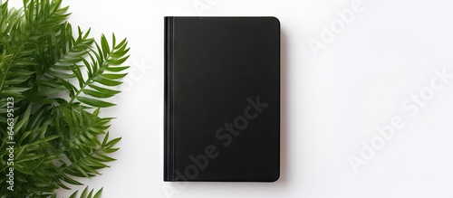 Black leather notebook mockup on light isolated pastel background Copy space designed to look like a photograph
