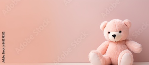 A photographic image of a teddy bear in a studio isolated pastel background Copy space