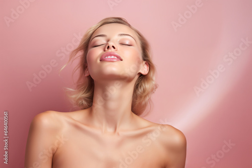 young woman with healthy skin showing skincare.close eyes   in pink background