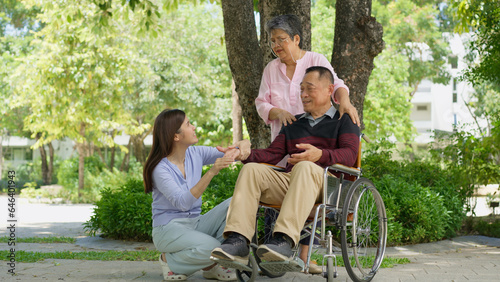 A daughter taking care of the patient in a wheelchair and talk with mom. Concept of happy retirement with care from a caregiver and Savings and senior health insurance, Happy family and retirement