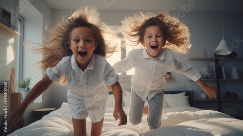 Children jumping on a bed in a bedroom because they are super happy