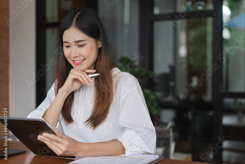 Businesswomen reading data on tablet and thinking about new startup while working in outside office Free Download Businesswomen reading data on tablet and thinking about new startup while working in outside office - GFXLoad