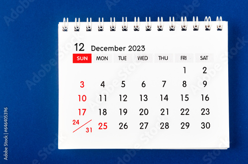 The December 2023 Monthly desk calendar for 2023 year on dark blue background.