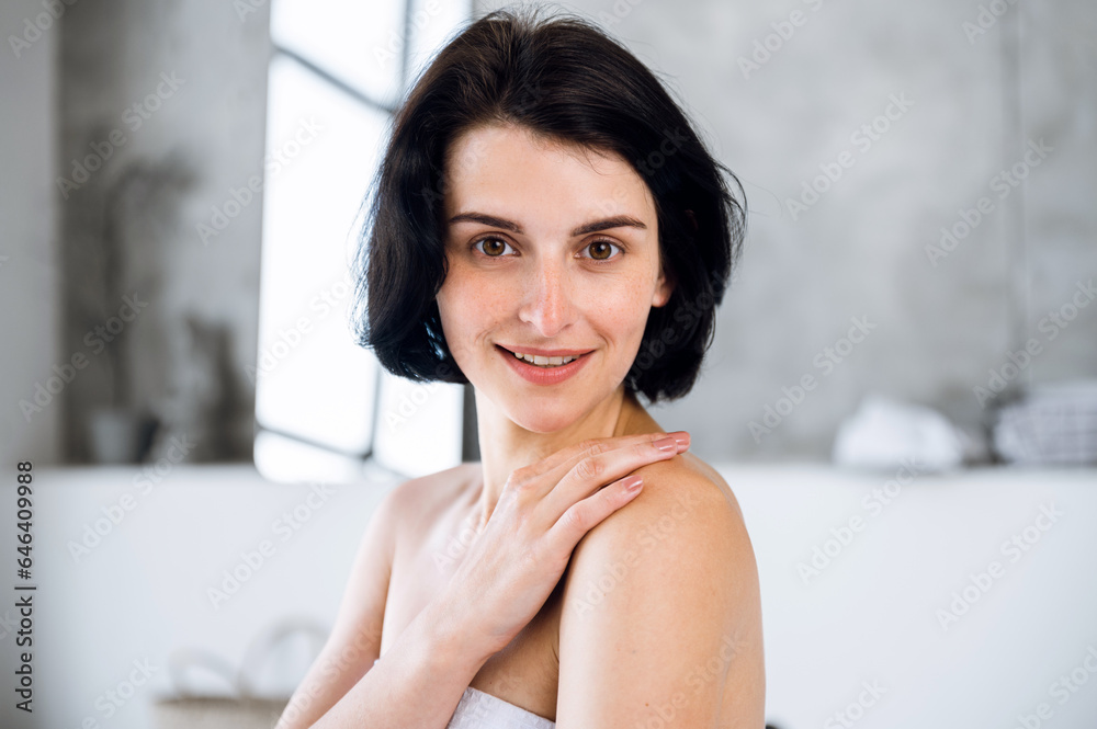 Woman touching shoulder, feeling soft smooth skin and smile Woman touching shoulder, feeling soft smooth skin and smile