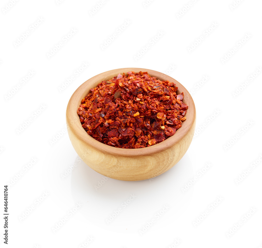 Crushed red pepper in wooden bowl isolated on white background Crushed red pepper in wooden bowl isolated on white background