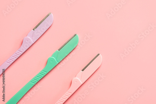 Top view of different dermaplaning tools with space for text. Skin care products and beauty concept