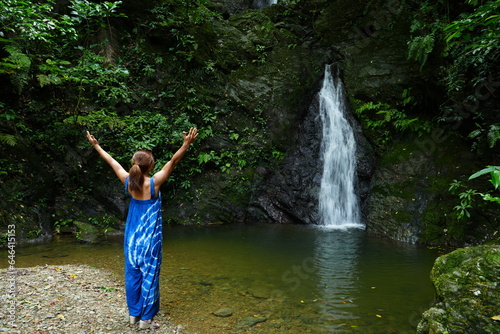 Woman With Open Arms at Kijoka Seven Falls in Okinawa -                                                             