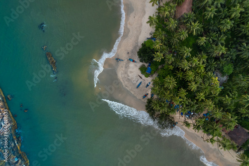 Beach top view with coconut trees and fishing boat