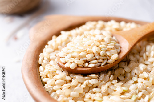Close-up of Yamani rice in a clay bowl and a wooden spoon. 