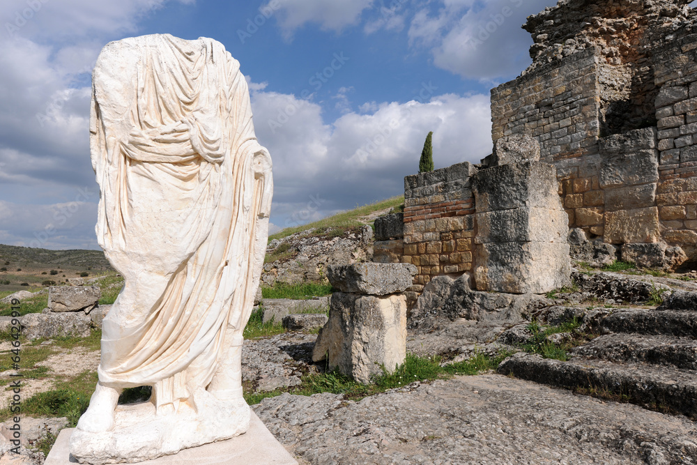 Headless statue wearing a toga, Roman ruins of Segobriga, Spain - obrazy, fototapety, plakaty 
