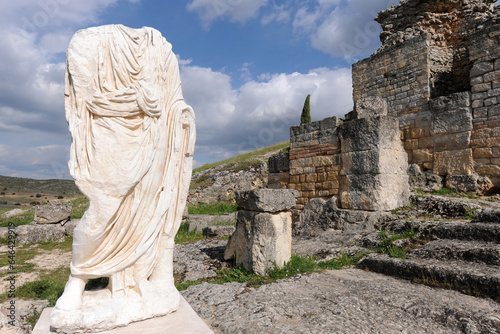 Headless statue wearing a toga, Roman ruins of Segobriga, Spain photo