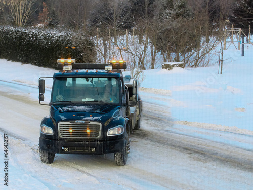 A tow truck in winter.
