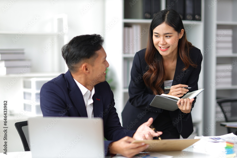 Boss and secretary working on documents together in office. Businessman and colleagues discussing in office collaboration. Boss and secretary working on documents together in office. Businessman and colleagues discussing in office collaboration.