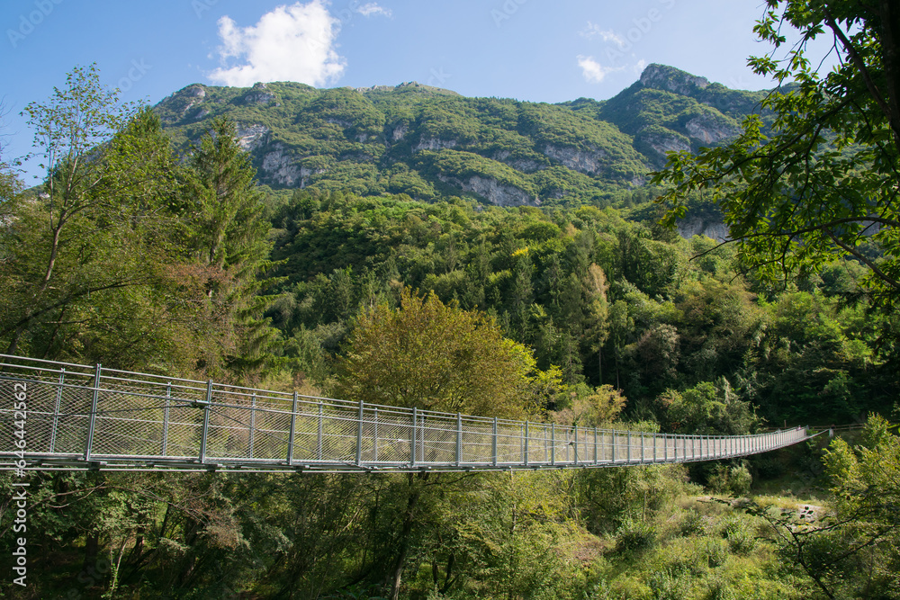 Panoramic view of suspended bridge in the nature in the Tenno lake, Trentino, Italy Panoramic view of suspended bridge in the nature in the Tenno lake, Trentino, Italy