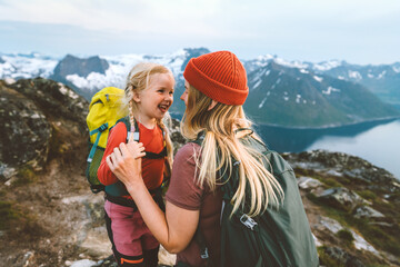 Mother hiking with daughter in Norway mountains travel together family time healthy lifestyle active vacations woman playing with child Mother's day holiday
