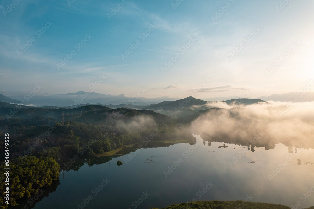 Fototapeta premium Foggy morning lake landscape photo, Misty morning aerial drone shot from Kannur Kerala