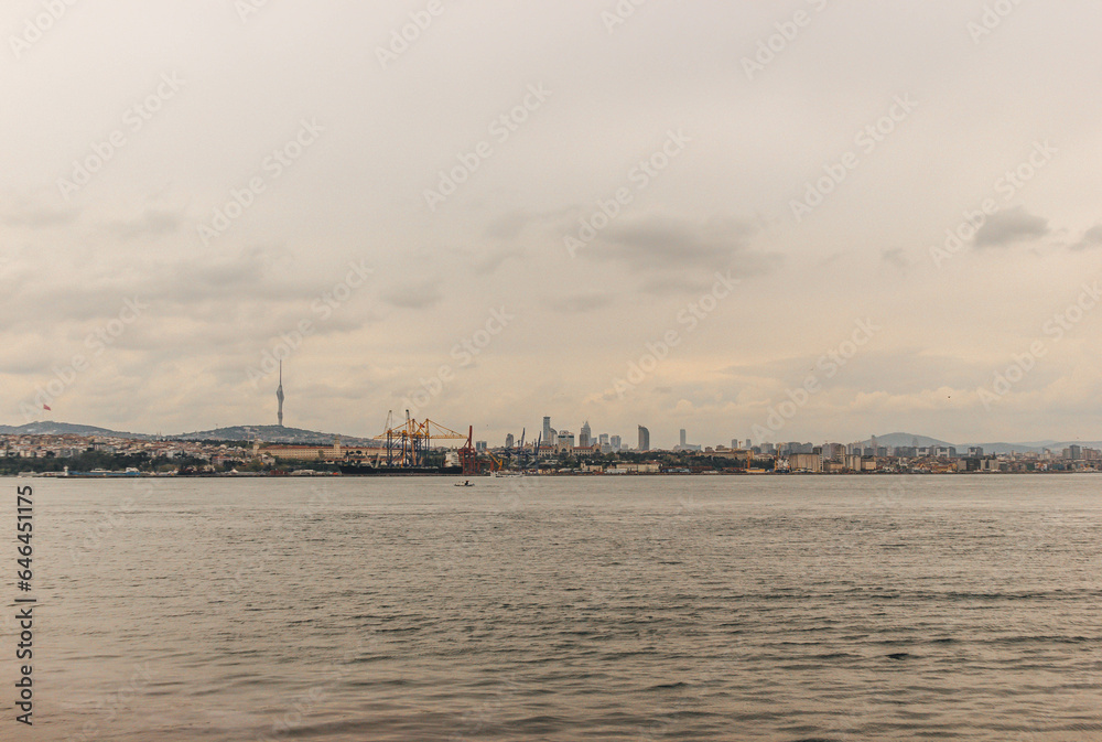 View of bosphorus strait water at mid day with light and bridge with skyline