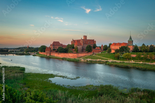 The Castle of the Teutonic Order in Malbork by the Nogat river at sunset. Poland © Patryk Kosmider