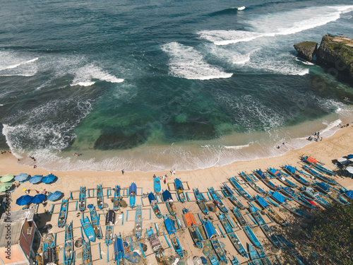 Aerial drone view of umbrellas at the beach in Yogyakarta Indonesia photo