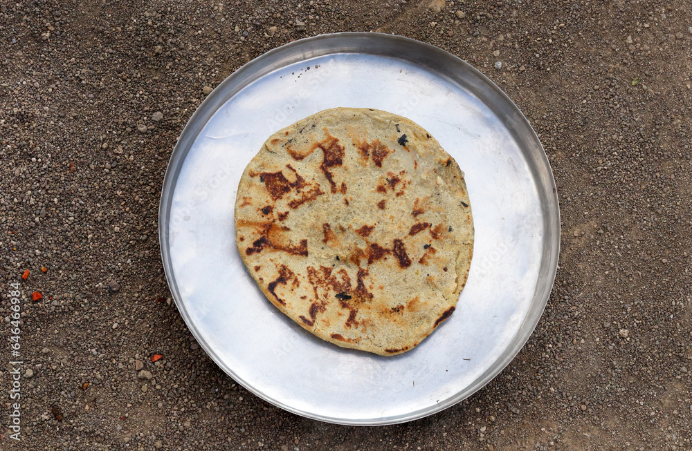Gujarati traditional sorghum ki roti or pearl millet flat bread. farmer's lunch or common items eaten in lunch which are bajre ki roti. Jowar Roti or Indian bread, eaten by working class in rural area